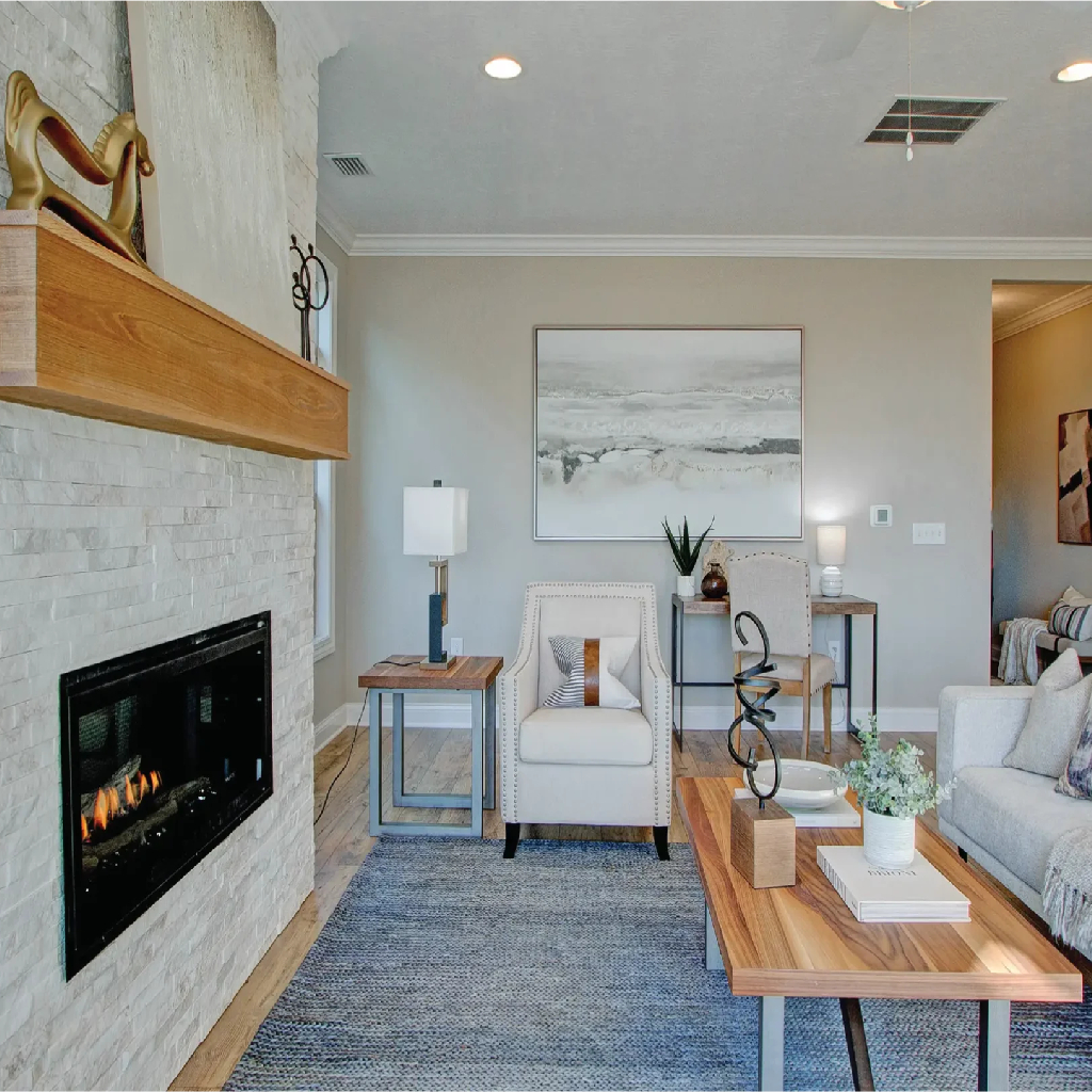 Elegant living room showcasing a fireplace and a comfortable couch, part of The Capri model home design.