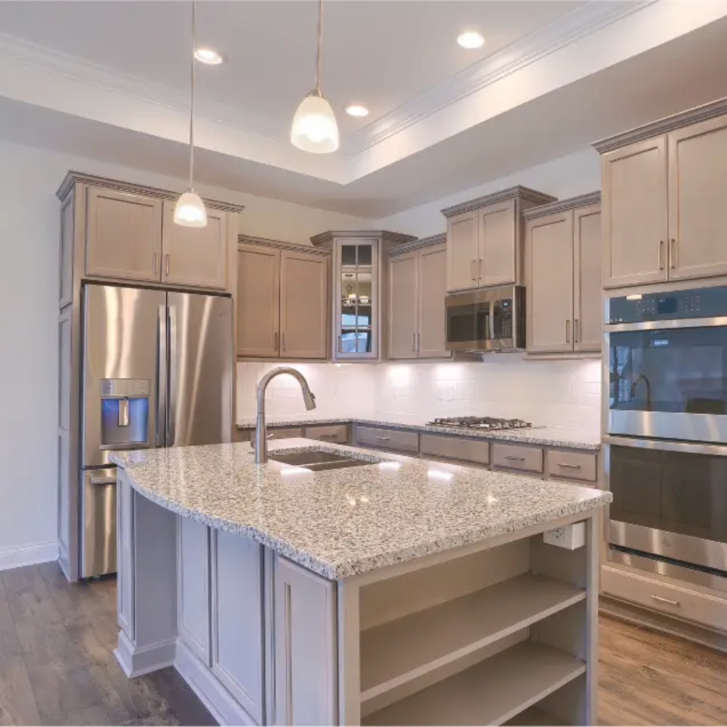 A modern kitchen featuring black cabinets and stainless steel appliances, designed as the Palazzo model by New Leaf Homes.