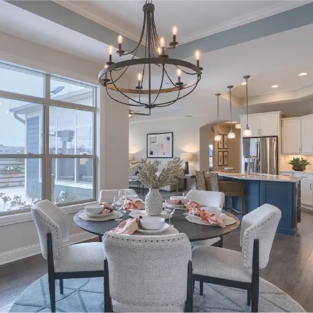 A cozy living room featuring a fireplace and sliding glass doors, designed as the Portico model by New Leaf Homes.