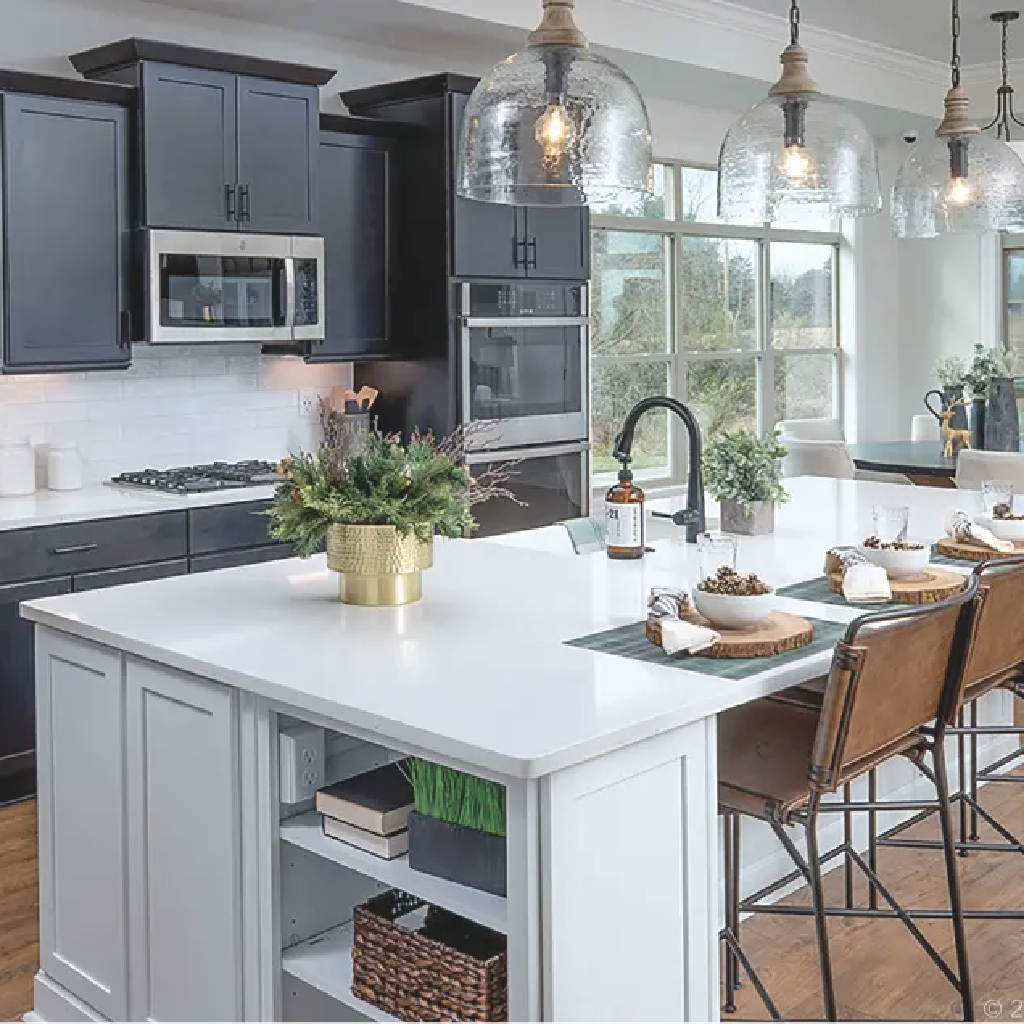 A Torino kitchen by New Leaf Homes featuring a center island and elegant hardwood floors.