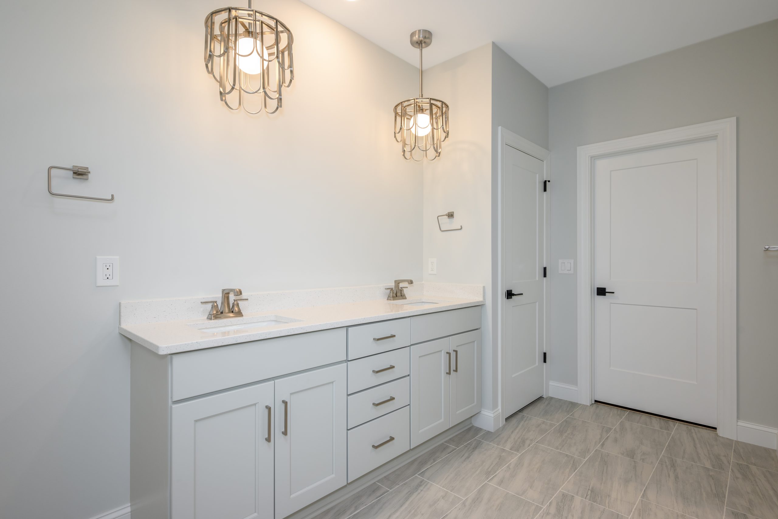 A modern bathroom of the move-in ready home located at 3348 Willow Lane, featuring a Torino model by New Leaf Homes, equipped with a shower, toilet, and sink.